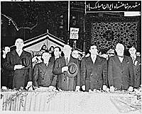 Photograph of President Truman, the Shah of Iran, Secretary of State Dean Acheson, and other dignitaries standing at attention, during ceremonies welcoming the Shah to Washington., 11/16/1949 - ARC Identifier: 200144.
