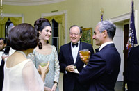 In conversation before State Dinner (foreground, L-R) Lady Bird Johnson (back to camera), Lynda Johnson, V.P. Hubert 

Humphrey, Shah Mohammad Reza Pahlavi of Iran, 08/22/1967